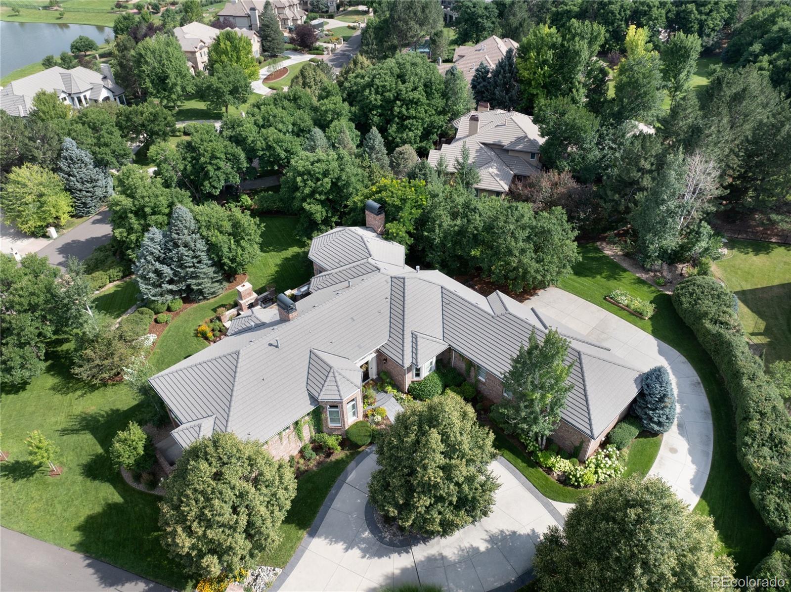 7175 Polo Ridge Drive Littleton, CO 80128 - Photo 46 of 50 an aerial view of a house with a yard and greenery