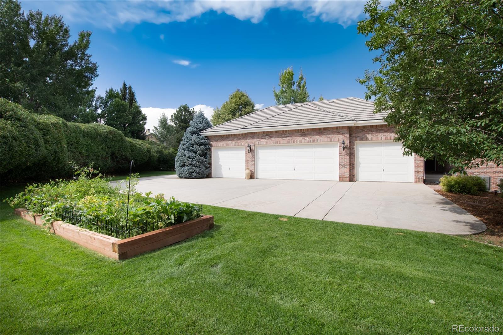 7175 Polo Ridge Drive Littleton, CO 80128 - Photo 48 of 50 a front view of a house with garden