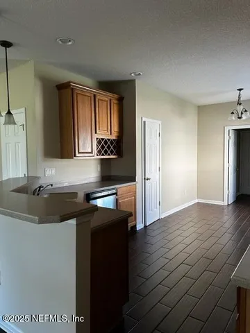 a kitchen with stainless steel appliances granite countertop a sink and wooden cabinets