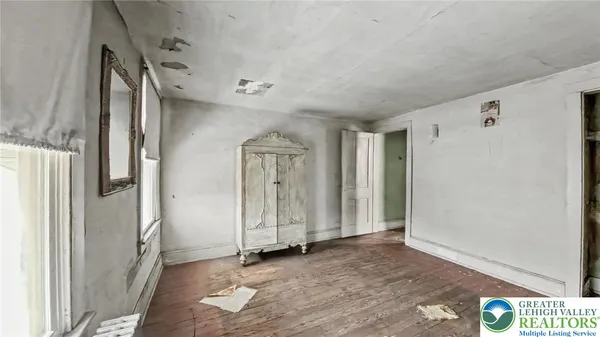 a view of hallway with wooden floor