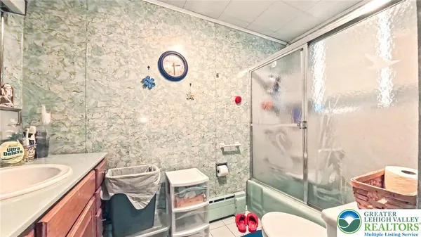 a bathroom with a sink mirror vanity and toilet