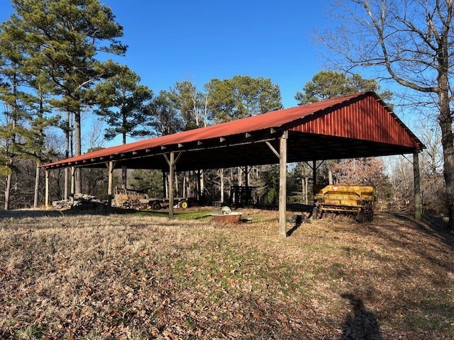 3915 Oak Ridge Road Palmyra, TN 37142 - Photo 59 of 61 a view of patio with a table and chairs under an umbrella