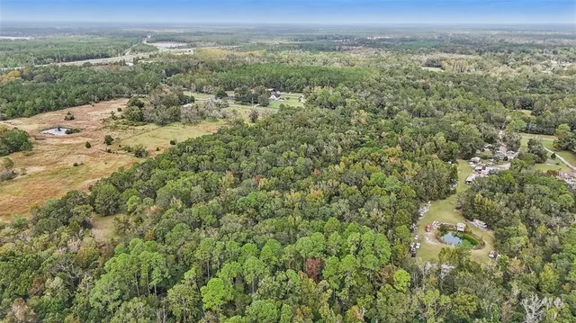 a view of a big yard with lots of green space