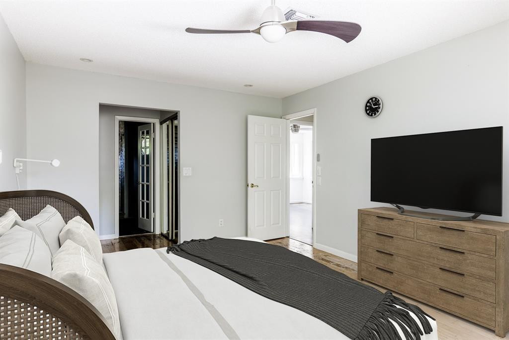 2945 Begonia Way Cooper City, FL 33026 - Photo 11 of 26 a bedroom with a bed and a flat screen tv