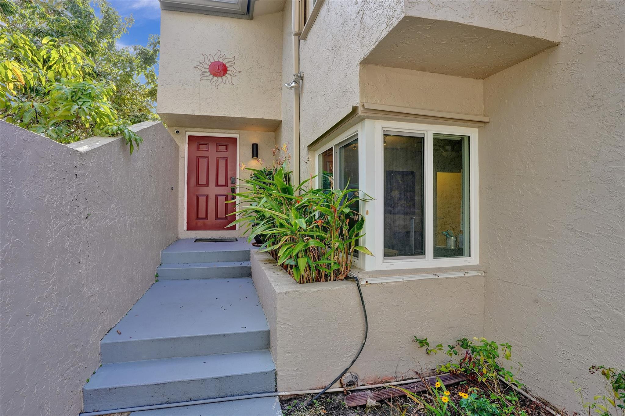 2945 Begonia Way Cooper City, FL 33026 - Photo 17 of 26 a potted plant sitting in front of a house