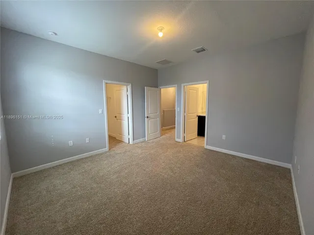 an empty room with a empty space and windows