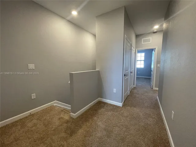 an empty room with mirror in a room