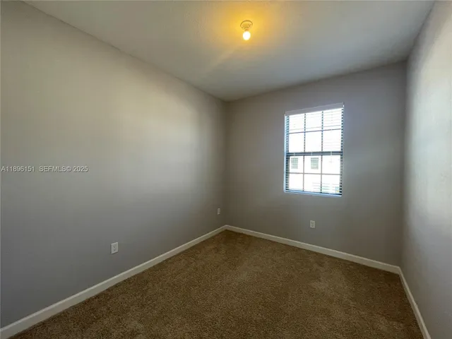 an empty room with mirror in a room