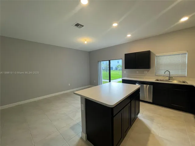 a kitchen with refrigerator and window