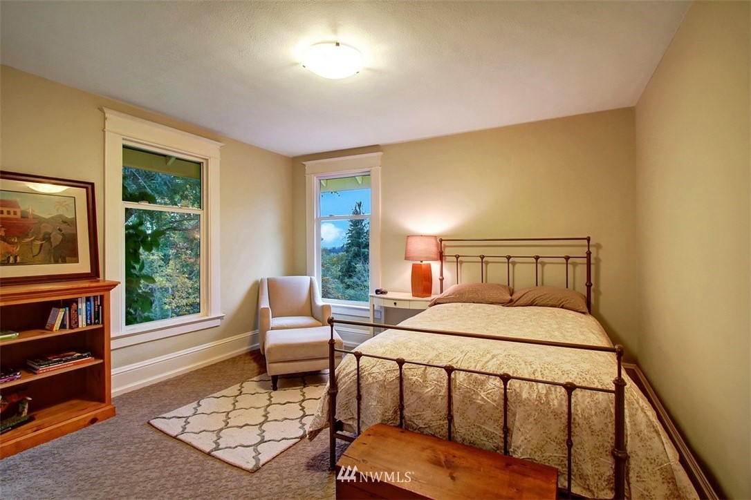 7405 Skipley Road Snohomish, WA 98290 - Photo 17 of 25 a bedroom with a bed and large windows