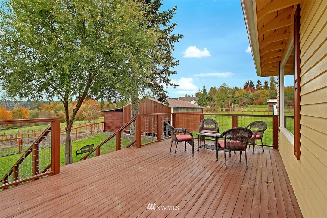 7405 Skipley Road Snohomish, WA 98290 - Photo 21 of 25 a view of a deck with table and chairs and wooden floor