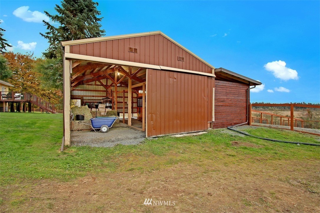 7405 Skipley Road Snohomish, WA 98290 - Photo 22 of 25 a view of a chair under an umbrella in front of house