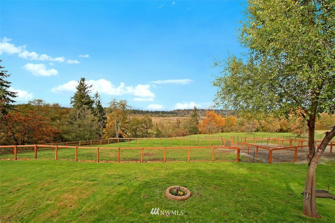 7405 Skipley Road Snohomish, WA 98290 - Photo 4 of 25 a view of a field with grass and a building