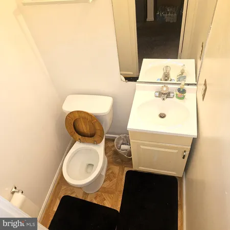 a bathroom with a sink a toilet and a mirror