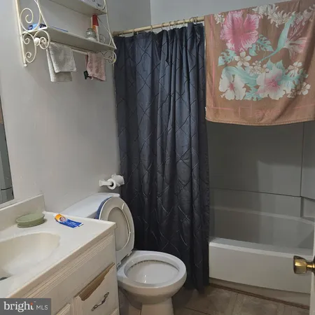 a bathroom with a sink a toilet and bathtub