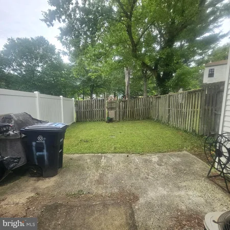 a view of backyard with trampoline