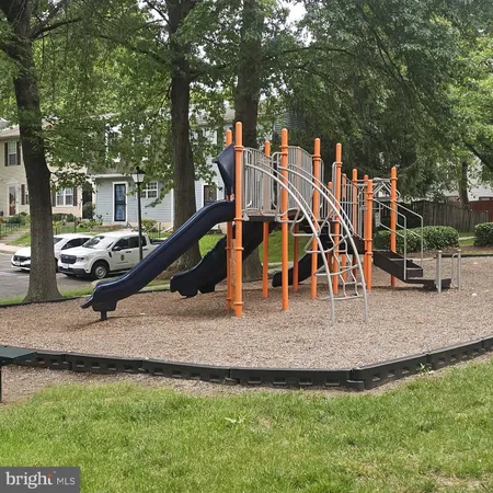 a view of outdoor space with playground and green space