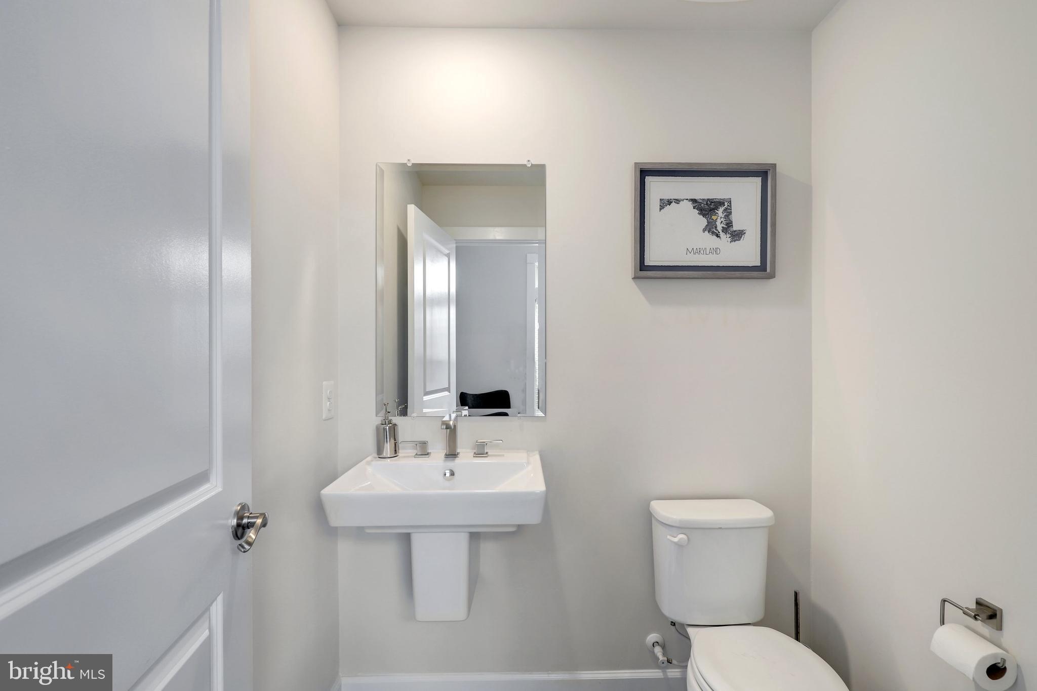 1028 Mutual Place Sandy Spring, MD 20860 - Photo 13 of 35 a bathroom with a toilet sink and mirror