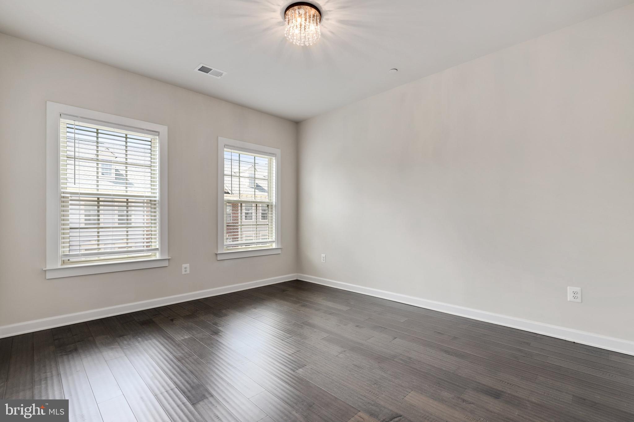 1028 Mutual Place Sandy Spring, MD 20860 - Photo 18 of 35 an empty room with wooden floor and windows