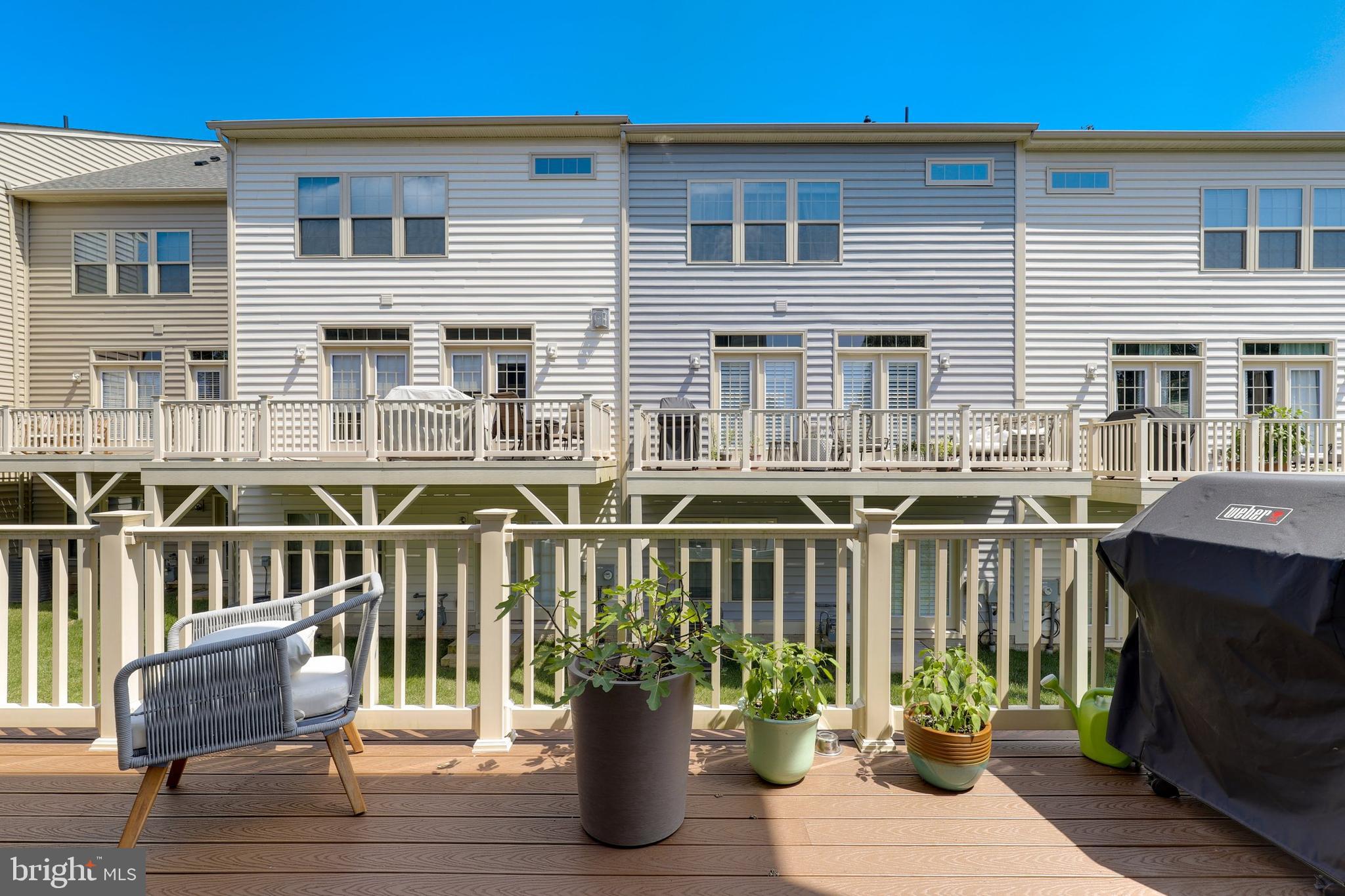 1028 Mutual Place Sandy Spring, MD 20860 - Photo 29 of 35 a view of a deck with two chair and a potted plant