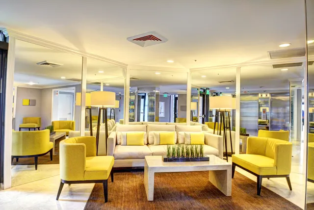 a dining area with lots of wooden furniture and a large window