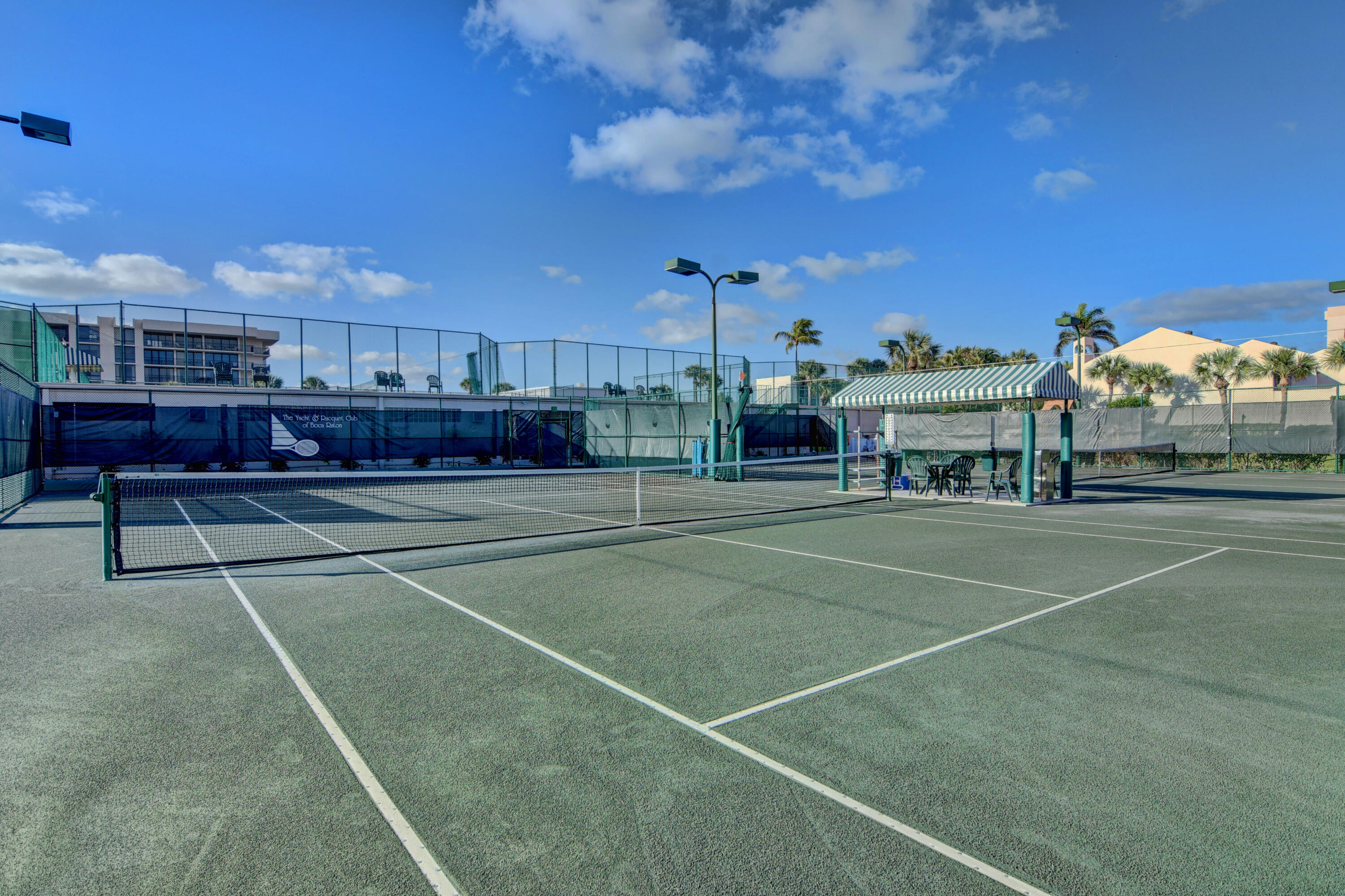 2707 North Ocean Boulevard, Unit D706 Boca Raton, FL 33431 - Photo 25 of 80 a view of a tennis ground with large trees