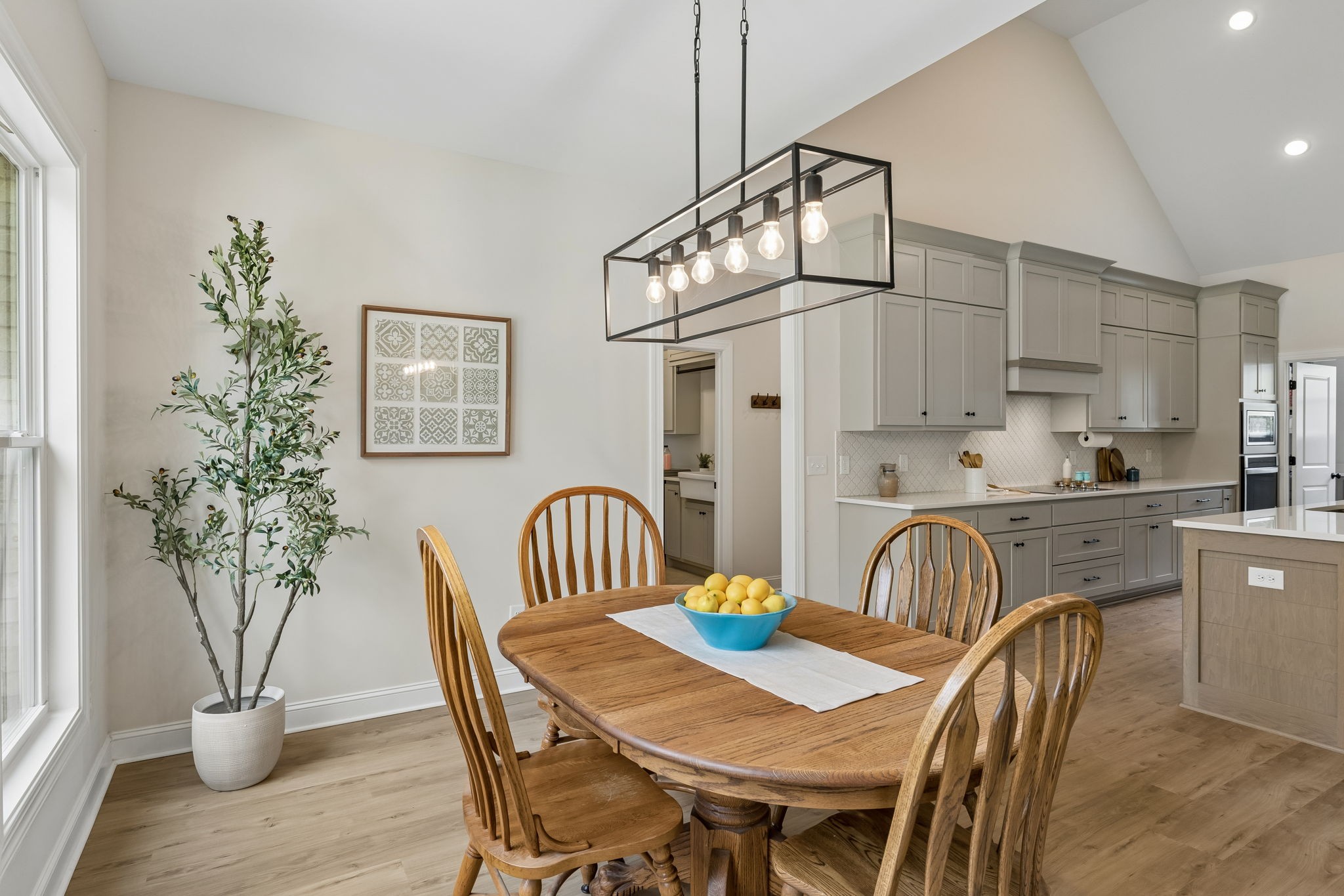 8708 Newtown Road Rockvale, TN 37153 - Photo 16 of 50 a dining room with furniture potted plants and wooden floor