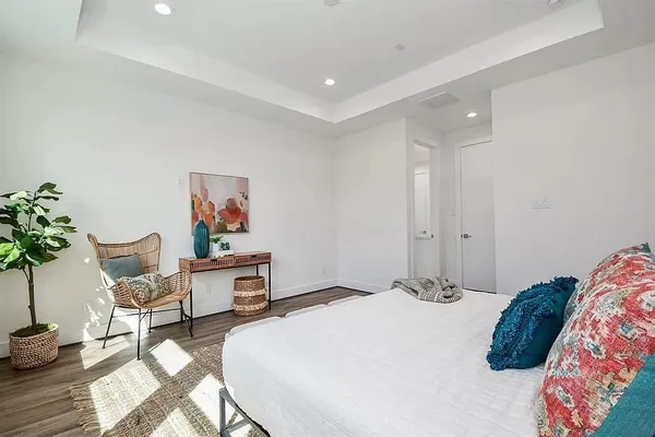 a bedroom with a bed and a potted plant