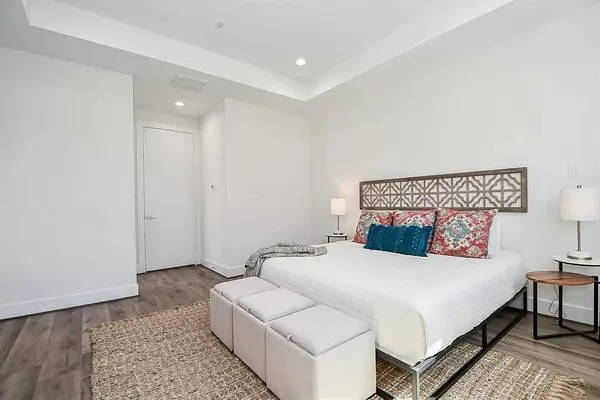 a bedroom with a bed and a night stand
