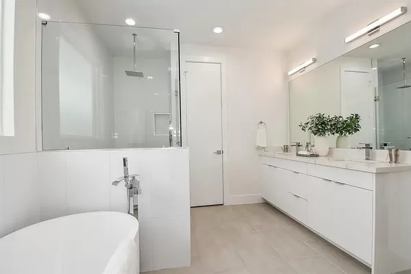 a bathroom with a bathtub shower sink and toilet