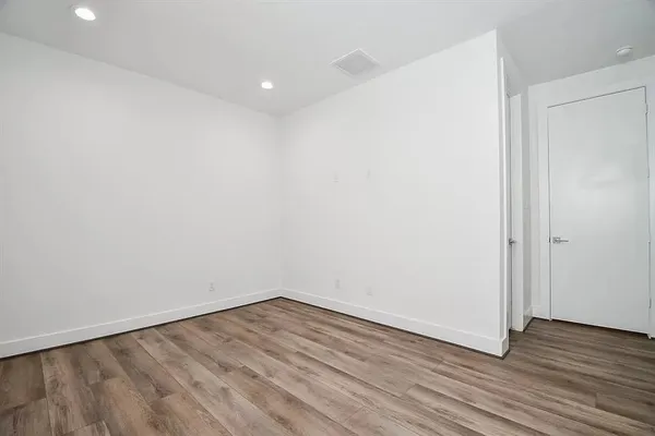 a view of a room with wooden floor