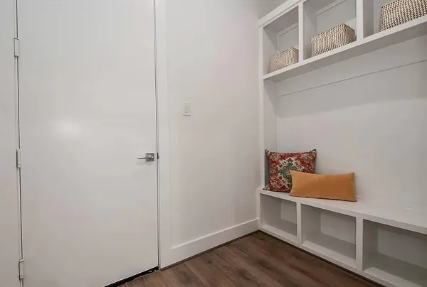 a room with wooden floor and book shelf