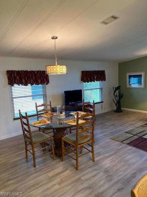 139 Rookery Road Naples, FL 34114 - Photo 15 of 37 a view of a dining room with furniture and wooden floor