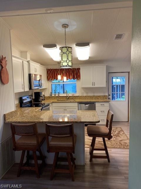 139 Rookery Road Naples, FL 34114 - Photo 17 of 37 a kitchen with a dining table chairs and wooden floor