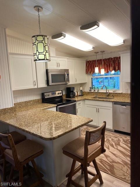 139 Rookery Road Naples, FL 34114 - Photo 18 of 37 a kitchen with a table chairs and a refrigerator