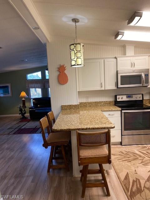 139 Rookery Road Naples, FL 34114 - Photo 19 of 37 a view of a kitchen with a table and chairs