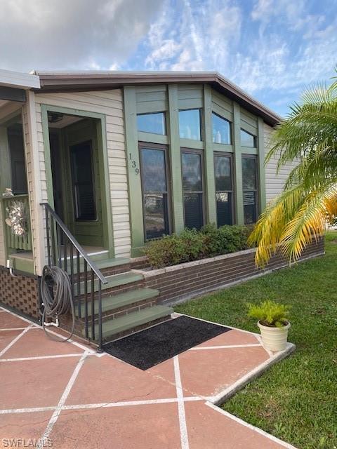 139 Rookery Road Naples, FL 34114 - Photo 2 of 37 a front view of a house with garden