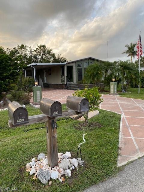 139 Rookery Road Naples, FL 34114 - Photo 4 of 37 a front view of a house with garden