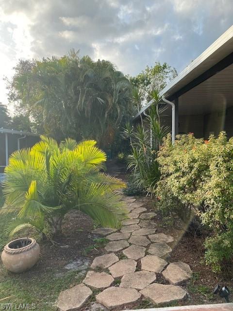 139 Rookery Road Naples, FL 34114 - Photo 7 of 37 a view of a backyard with plants and a garden