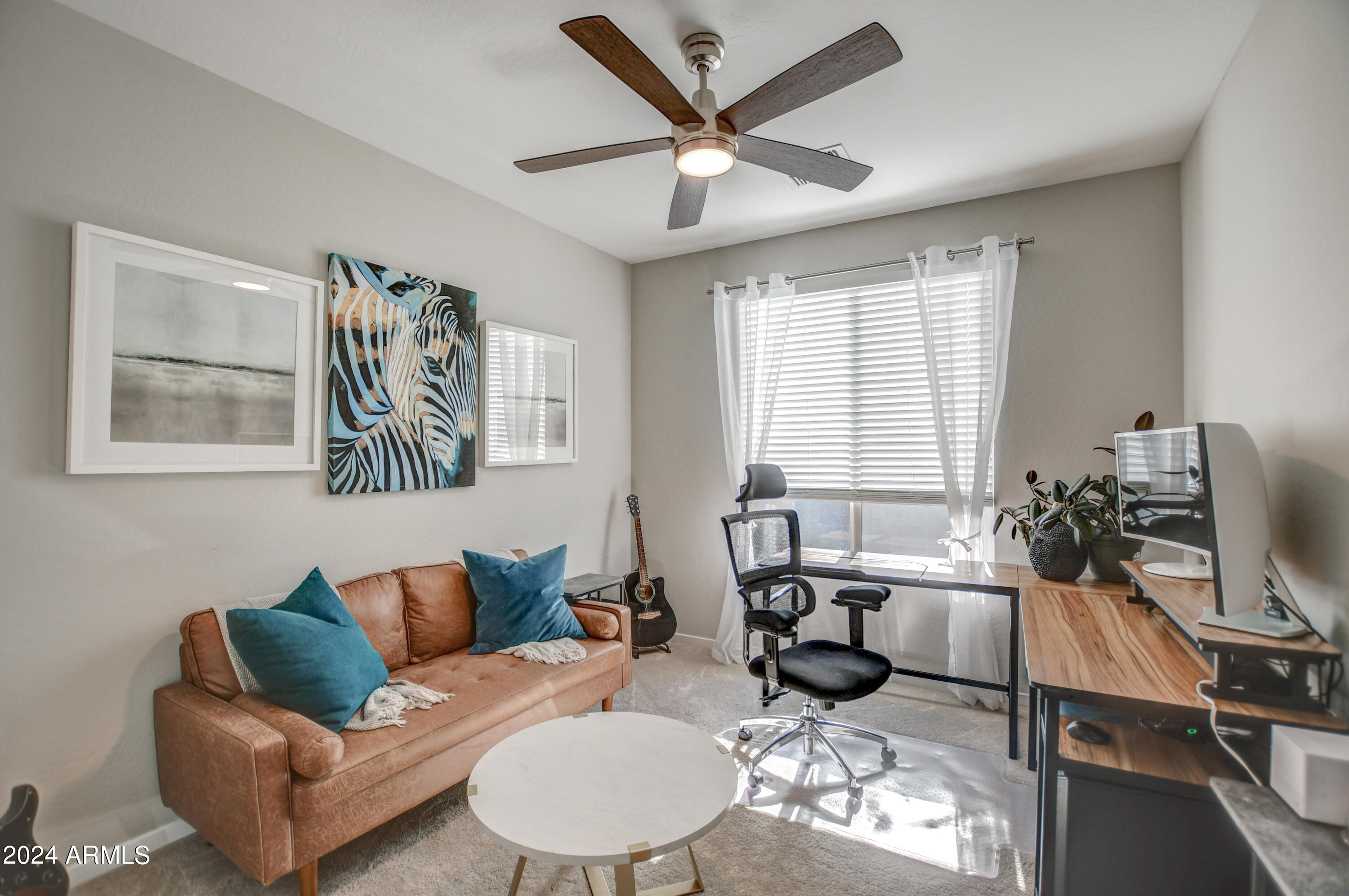 a living room with furniture a flat screen tv and a window