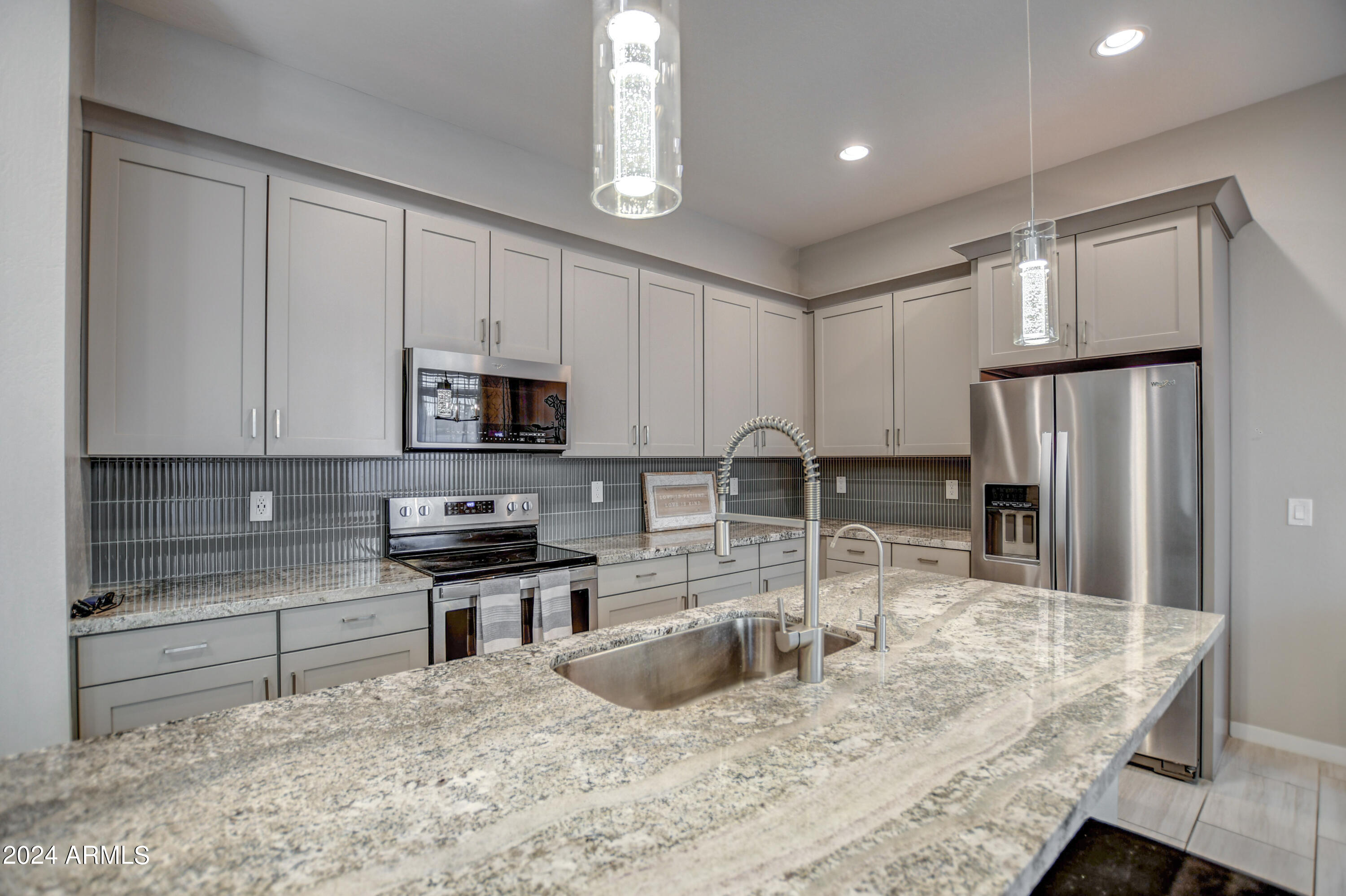 901 South Smith Road, Unit 1033 Tempe, AZ 85281 - Photo 12 of 43 a kitchen with granite countertop a refrigerator a sink a stove a microwave and island