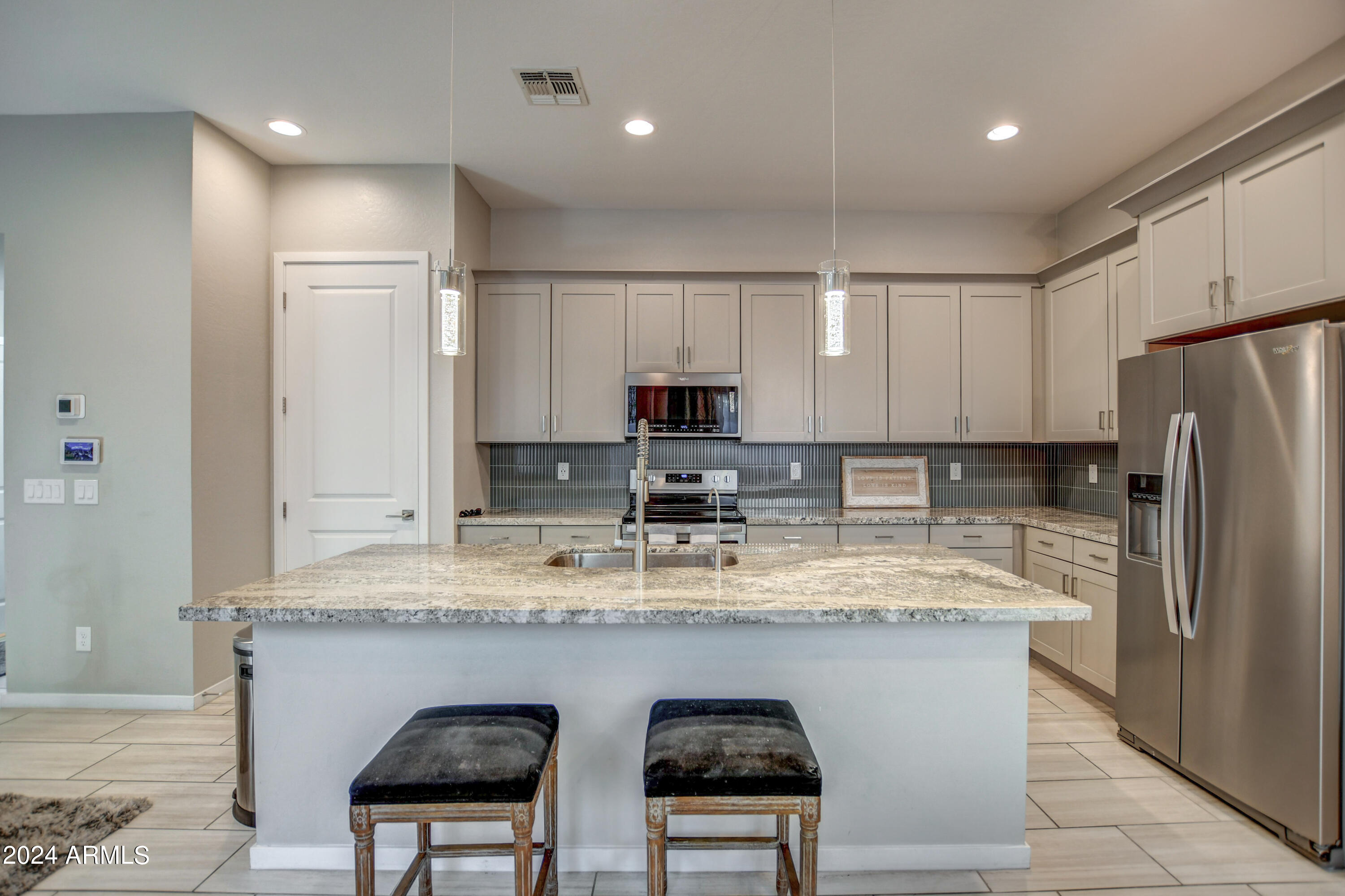 901 South Smith Road, Unit 1033 Tempe, AZ 85281 - Photo 13 of 43 a kitchen with stainless steel appliances granite countertop a sink a stove a refrigerator and cabinets