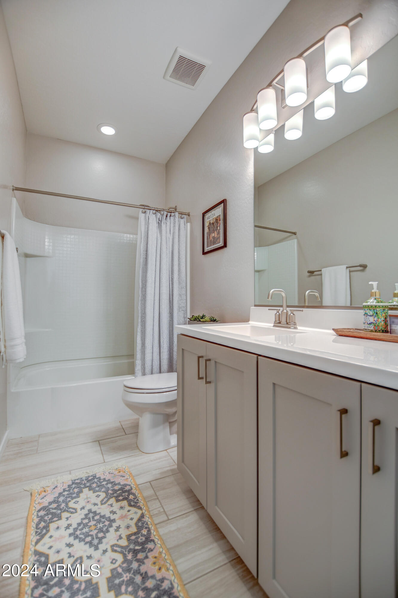 901 South Smith Road, Unit 1033 Tempe, AZ 85281 - Photo 18 of 43 a bathroom with a sink a toilet a mirror a vanity and shower