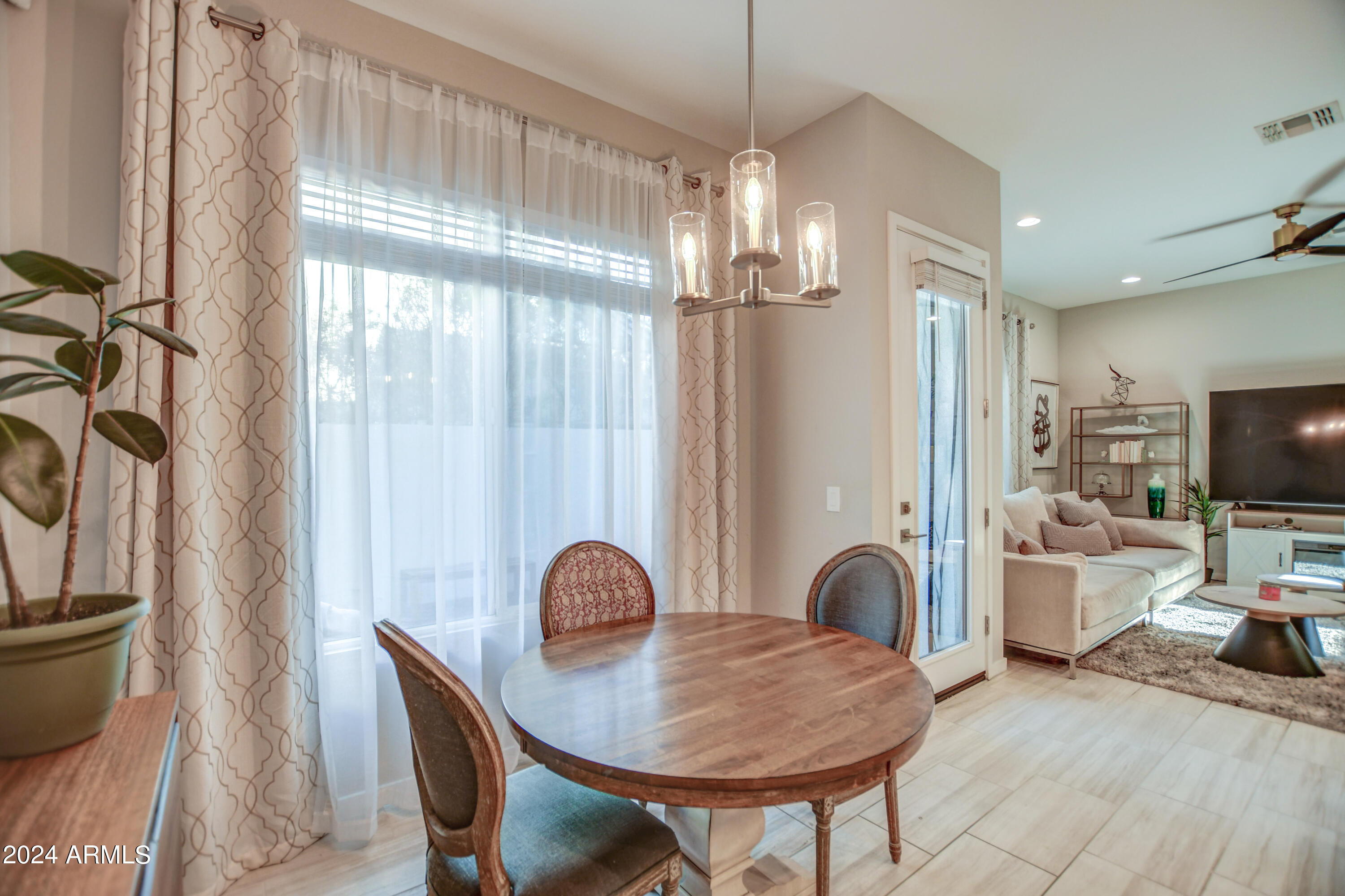 901 South Smith Road, Unit 1033 Tempe, AZ 85281 - Photo 21 of 43 a view of a dining room with furniture a chandelier and wooden floor