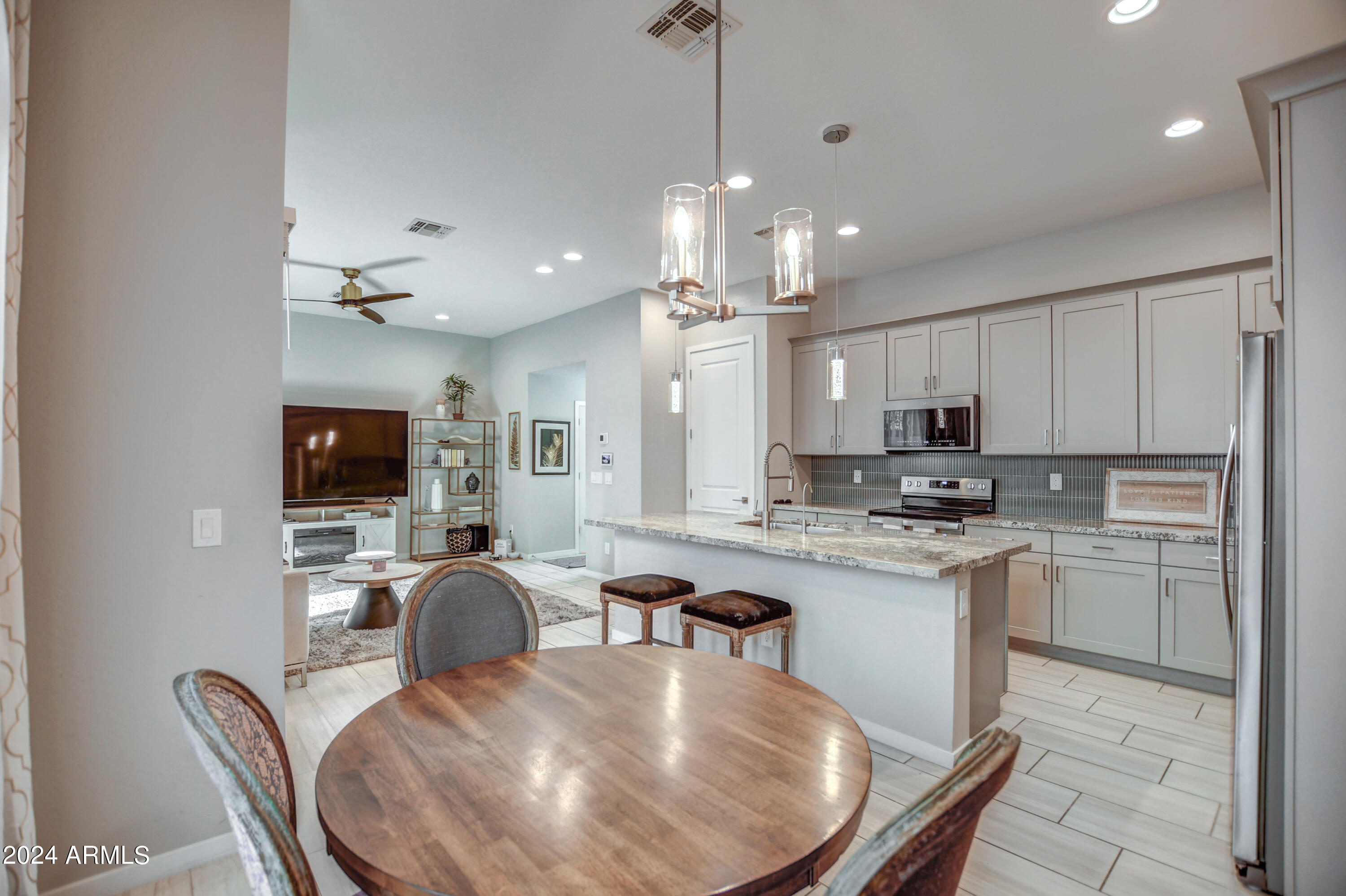 901 South Smith Road, Unit 1033 Tempe, AZ 85281 - Photo 3 of 43 a large kitchen with kitchen island a sink table and chairs