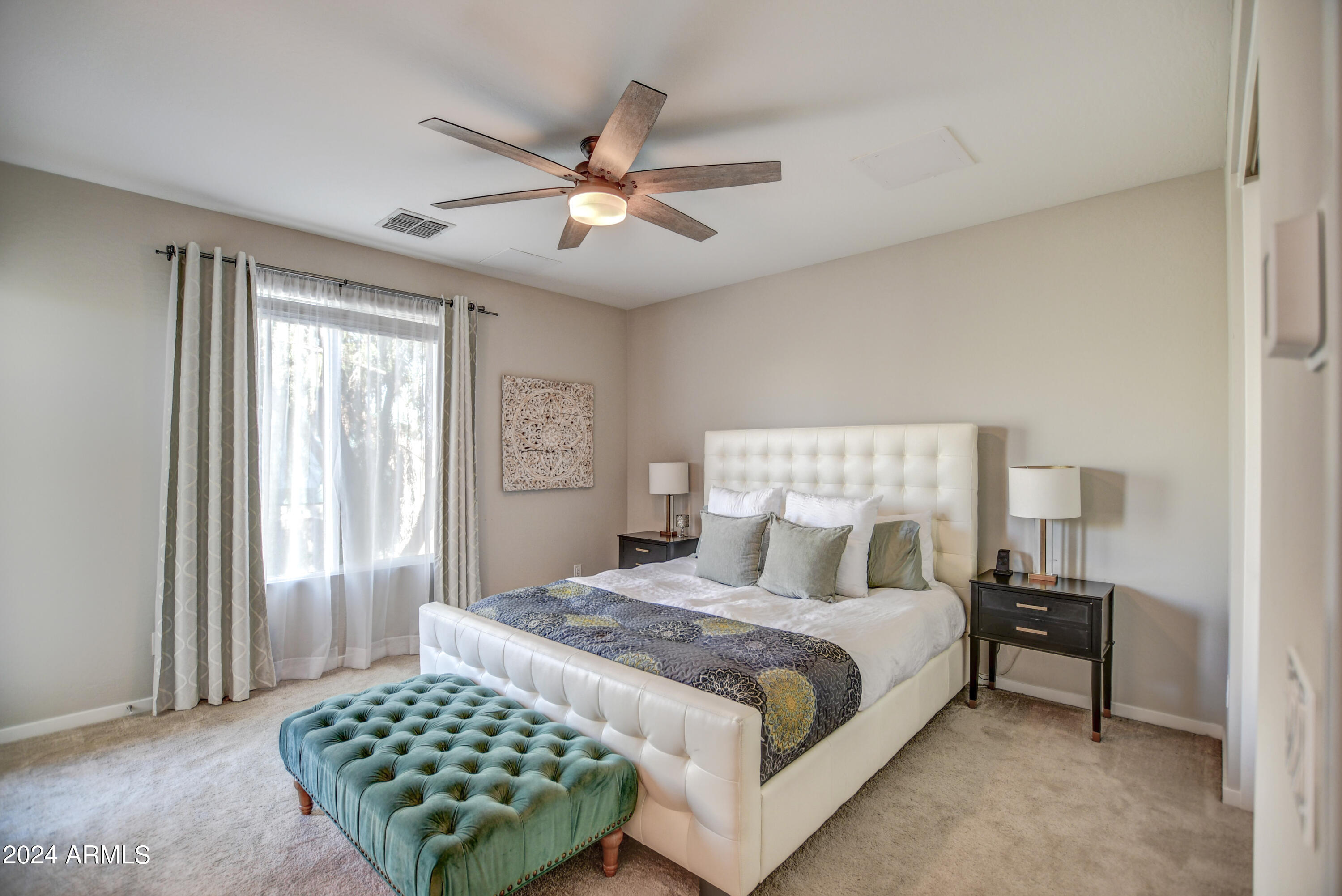 901 South Smith Road, Unit 1033 Tempe, AZ 85281 - Photo 33 of 43 a bedroom with a large bed and a chandelier