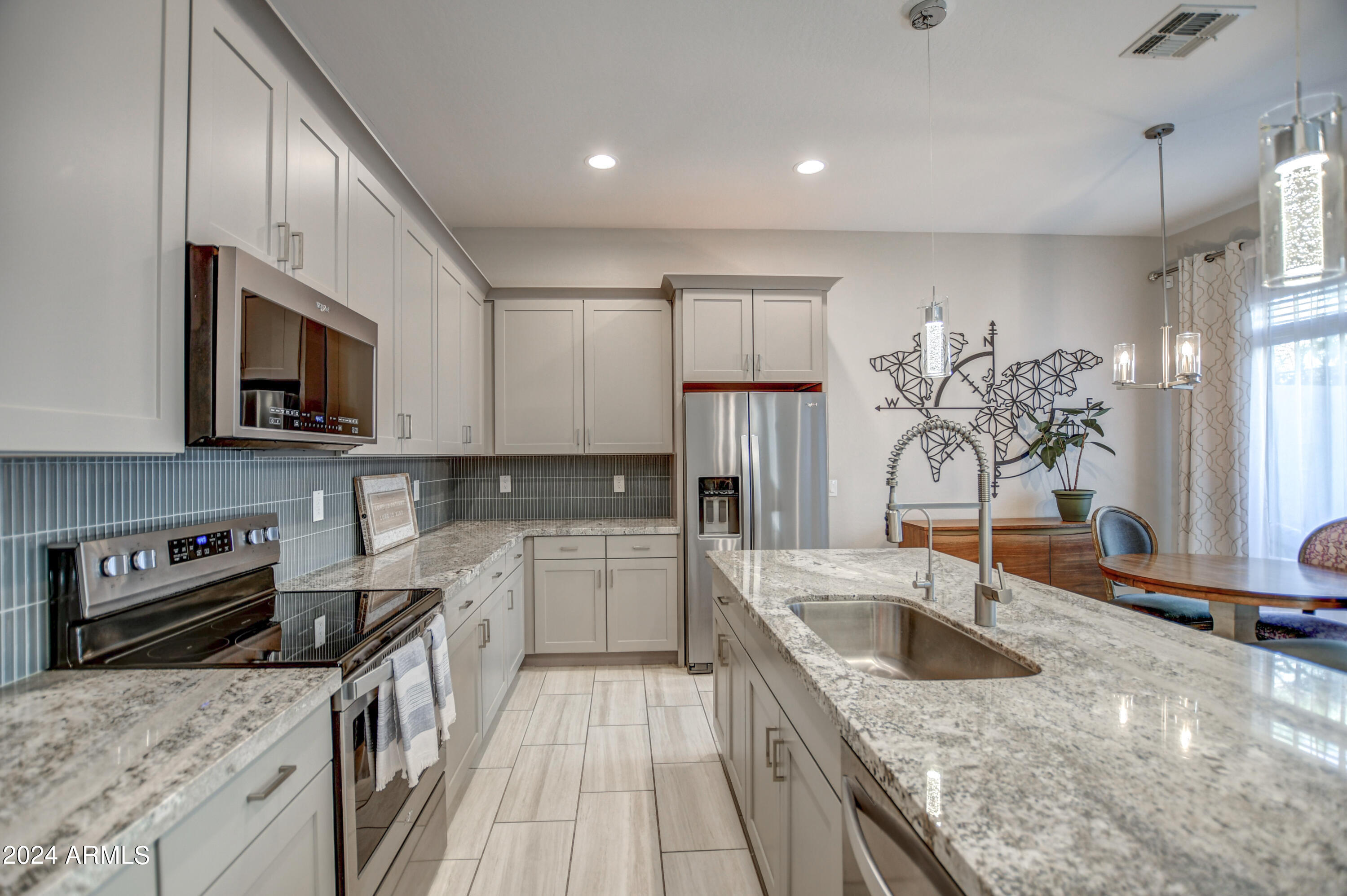 901 South Smith Road, Unit 1033 Tempe, AZ 85281 - Photo 9 of 43 a kitchen with a sink stove top oven and refrigerator
