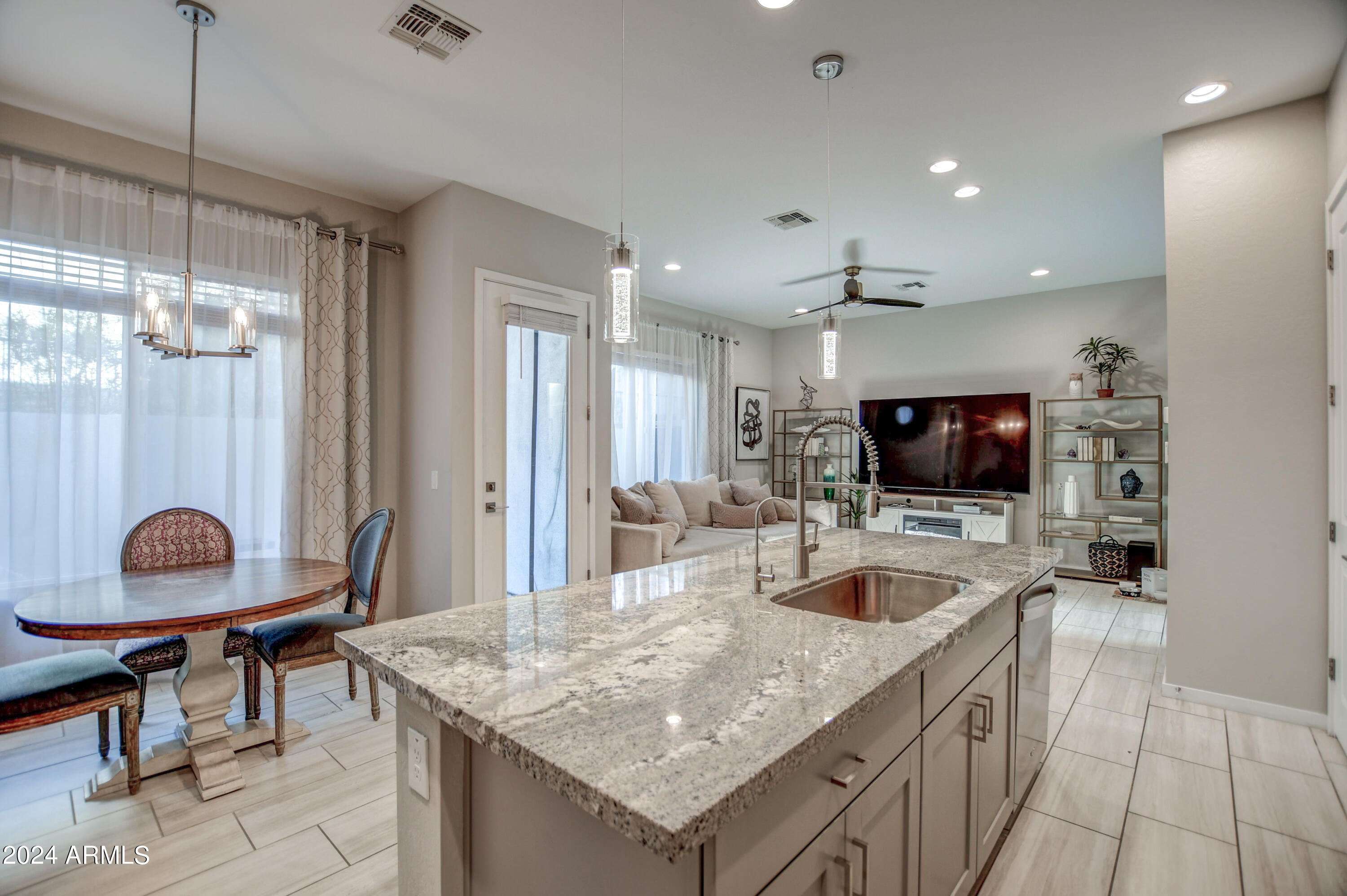 901 South Smith Road, Unit 1033 Tempe, AZ 85281 - Photo 10 of 43 a kitchen with granite countertop a sink and a stove