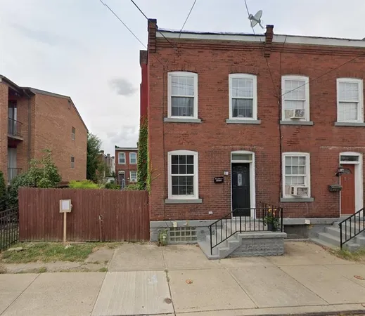 a view of a brick house with many windows