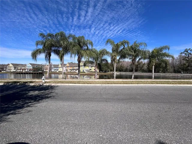 a front view of a house with garden and trees